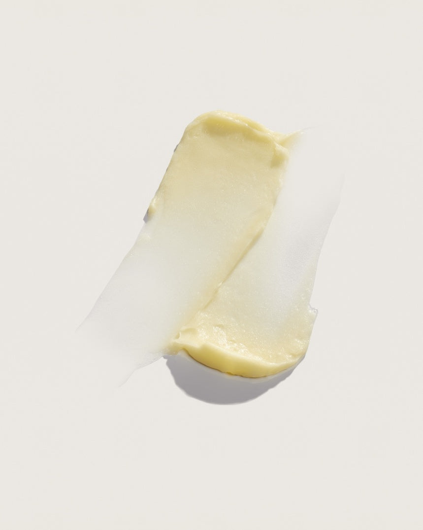 Creamy yellow cosmetic product swatch on white background