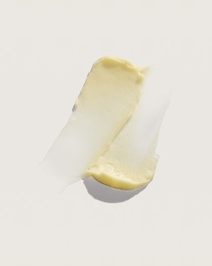 Creamy yellow cosmetic product swatch on white background