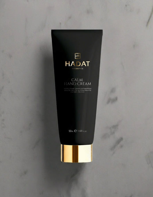Luxury black hand cream tube with gold cap on marble