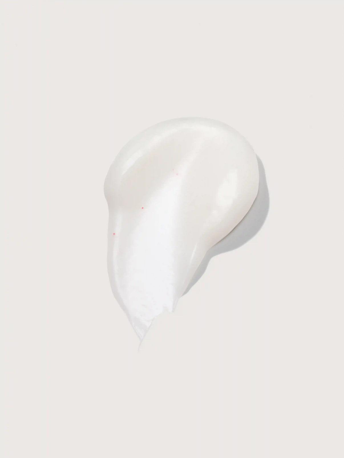 Smooth white cream with subtle red specks