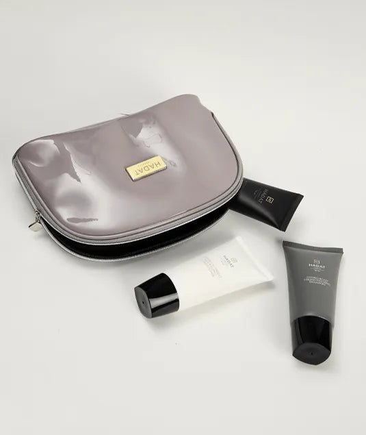Hadat cosmetics travel set with Sea Oil Silk products in sleek tubes and pouch