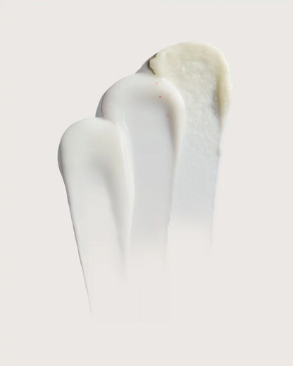 Smooth white cream texture with subtle red specks