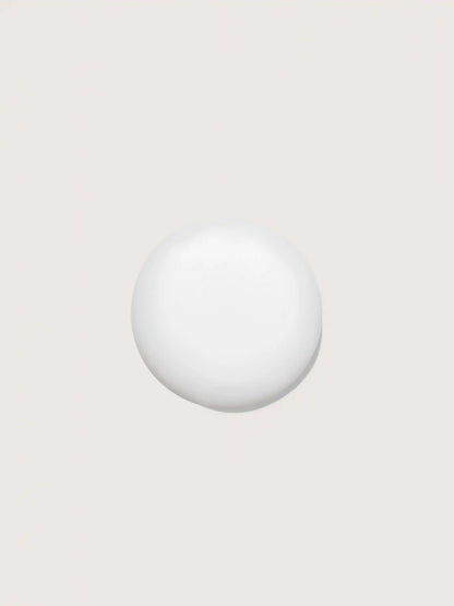Smooth white cosmetic sphere on neutral background