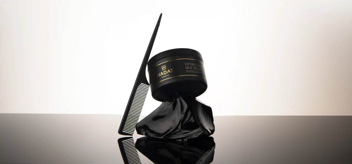 Hydro Liquid Silk Treatment with black comb on reflective surface