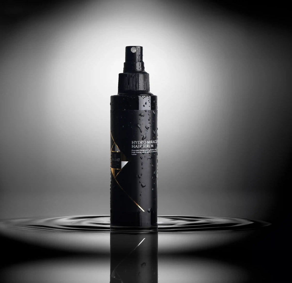 Hydro Miracle Hair Serum bottle with water droplets on dark reflective surface