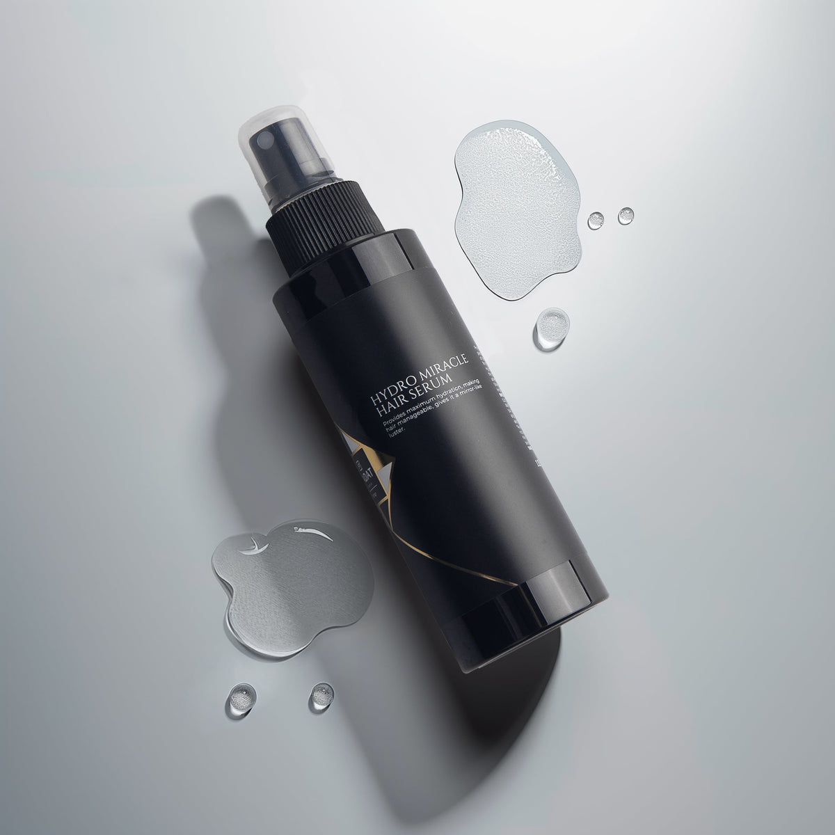 Hydro Miracle Hair Serum bottle with serum droplets