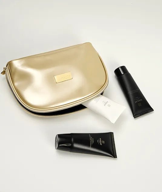 Luxury gold cosmetic bag with black skincare tubes