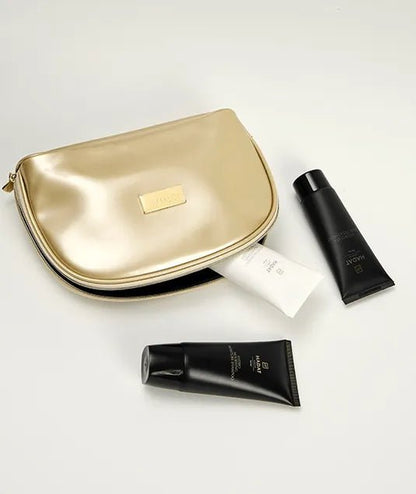 Luxury gold cosmetic bag with black skincare tubes