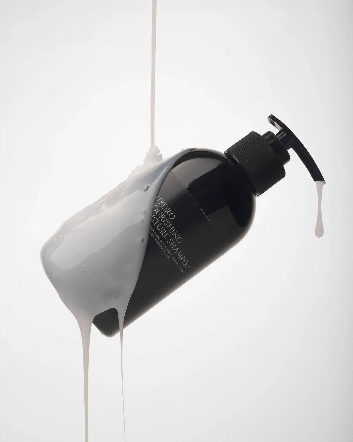 Hydro nourishing moisture shampoo bottle with creamy product pouring out