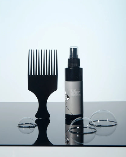 Hydro Texturizing Salt Spray with wide-tooth comb and bubbles on reflective surface
