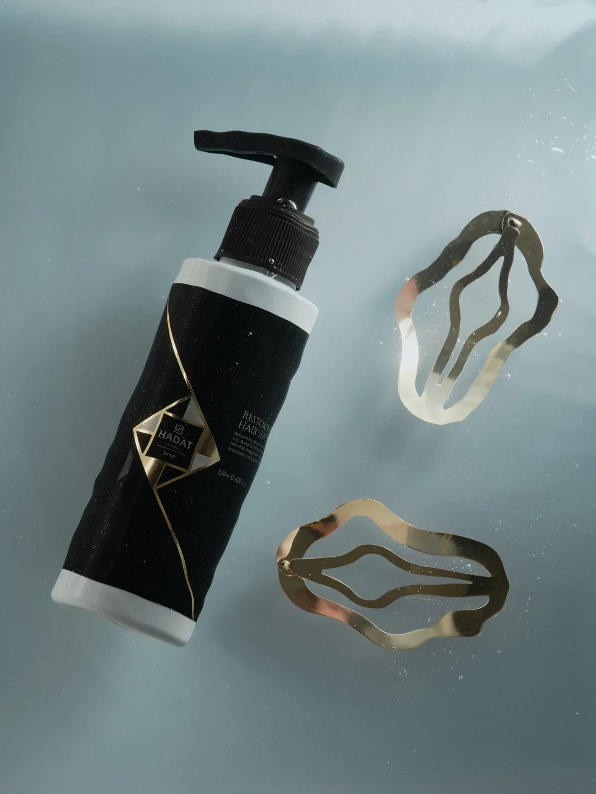 Restoring Pearl Hair Serum with gold hair clips